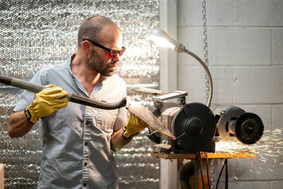stick welder with plasma cutter in action cutting through steel plate with sparks flying